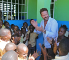 Gerard Butler and schoolchildren in Haiti - Love Reaches Everywhere